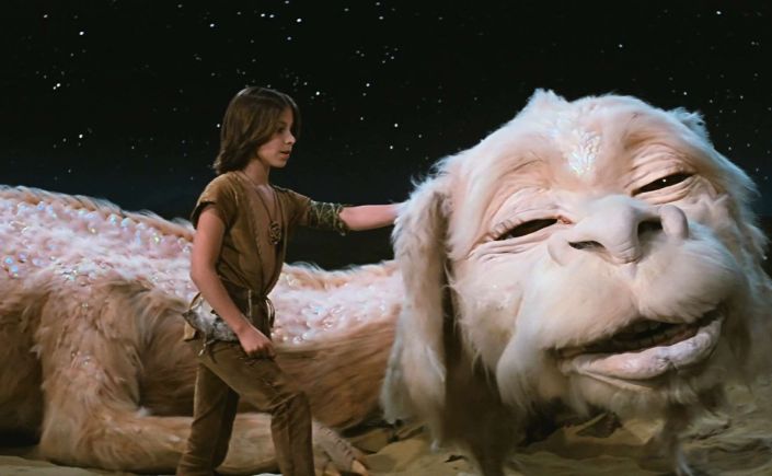 Falkor and Atreyu from the film The Neverending Story. Atreyu is scratching Falkor's ear.